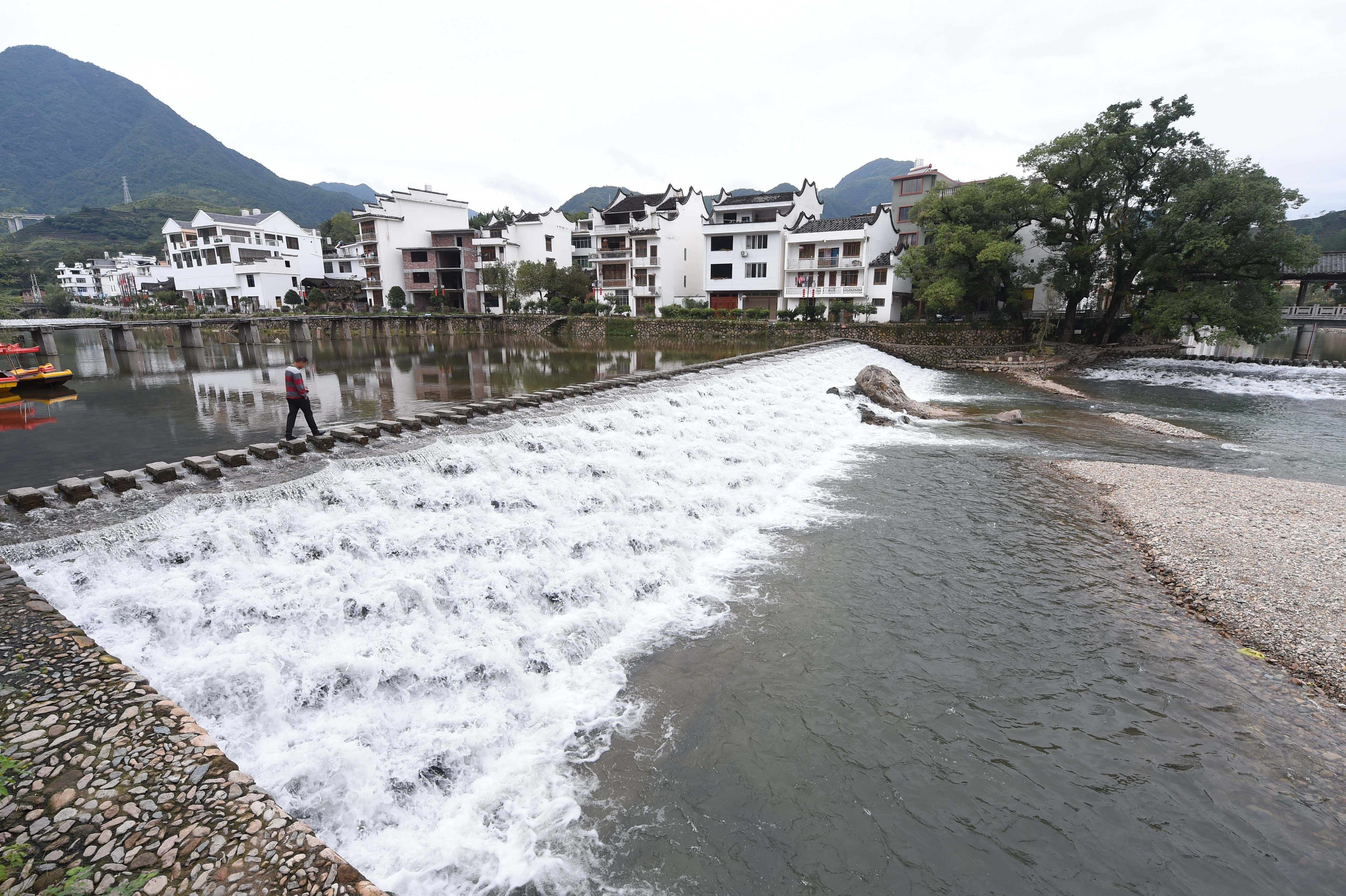 10月12日,行人从西浦村的"鱼鳞坝"的石板桥上走过.