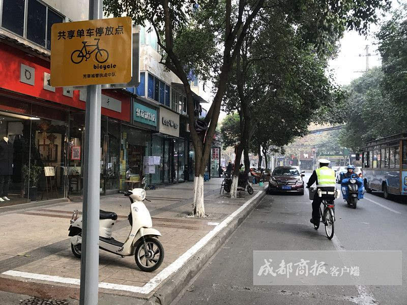 黄色的牌子上写着"共享单车停放点 ofo"