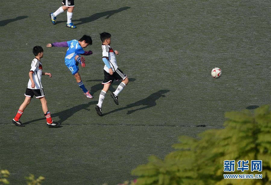 2月27日,在广西南宁市滨湖路小学足球场,小学生们在踢足球.
