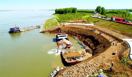 图为抢险人员在崩岸堤段进行抛石固脚作业. (记者 柯皓 摄)