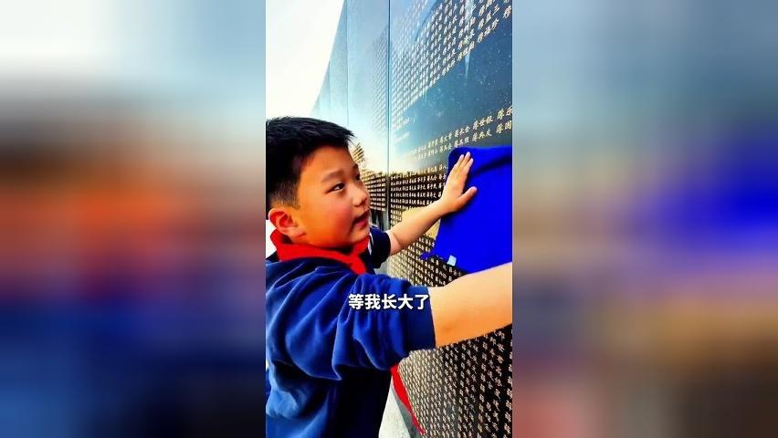 8岁小男孩踮脚跳起擦拭烈士名字：等我长大，为更高处的烈士擦名字